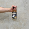 A hand holding a bottle of That boutique-y whisky company Ledaig 21 Year Old single malt Scotch whisky, with a label that includes the brand name and the batch number.